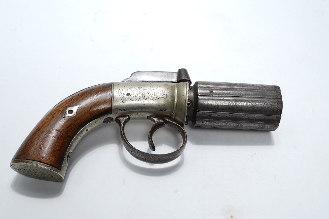 A six shot 120 bore self-cocking percussion pepperbox revolver with fluted barrels, Birmingham proof, rounded foliate engraved frame with ‘Improved Revolver’, and two-piece walnut grips